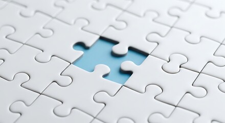 Close up of a white jigsaw puzzle with one piece missing symbolizing a challenge or a missing link in a plan