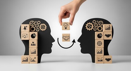 Creative collaboration and idea exchange represented by wooden blocks between two human head silhouettes suggesting partnership and knowledge sharing for business growth