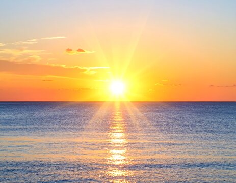 Picturesque seascape at daybreak with sun rays reflecting on the tranquil ocean water