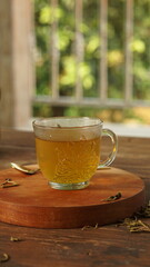 cup of tea, tea being poured into a transparent and white tea cup, teapot and tea cup with floral motif, darmkmood tea photo display