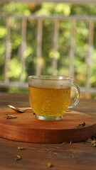 cup of tea, tea being poured into a transparent and white tea cup, teapot and tea cup with floral motif, darmkmood tea photo display
