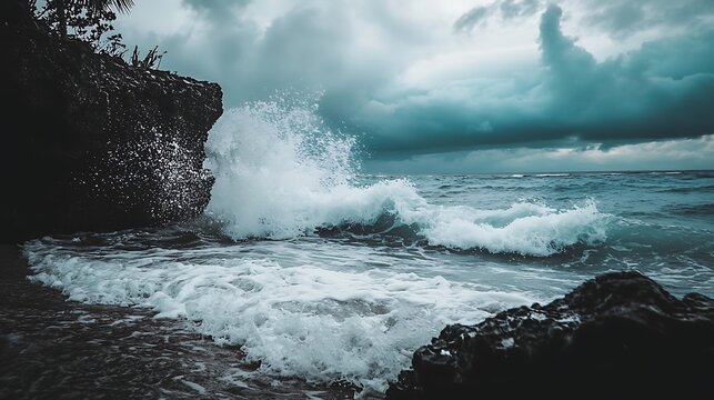 Dramatic ocean waves crashing against dark rocks under a stormy sky - Powered by Adobe