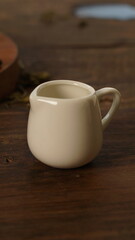 cup of tea, tea being poured into a transparent and white tea cup, teapot and tea cup with floral motif, darmkmood tea photo display