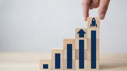 Business growth visualized with stacked blocks, upward trends, and a rocket symbol for launch success.