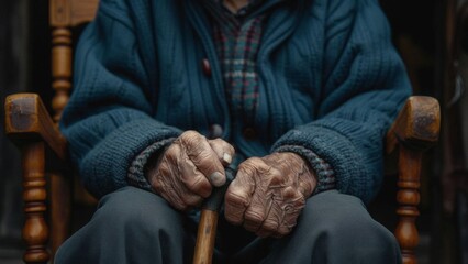 Close up of an elderly man holding a wooden walking cane. Concept of old age, retirement, and support for aging population.