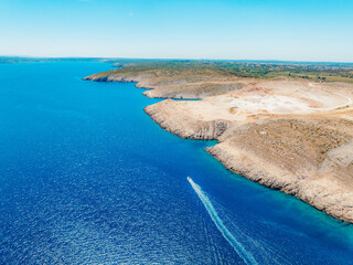 Vrsi near Zadar archipelago cove beach in stone desert scenery near Zecevo island, Dalmatia in Croatia and Pag Island in background. Boat trip © Zedspider