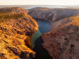 View of the Zrmanja River Canyon in Croatia, with winding turquoise waters cutting through...