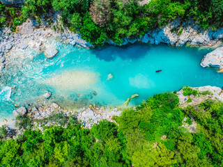 Rafting and kayaking place on the river. Kayakers in colorful life jacket paddling in Soca river, kobarid, Triglav National Park, Slovenia