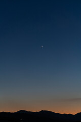 crescent moon on the mountain in the evening