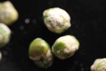 Close up shot of coated green peas as background