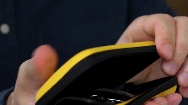 A person puts glasses in a case for storage.
Storing glasses for vision in a special shockproof case so as not to damage them.
Protecting glasses from falls and impacts