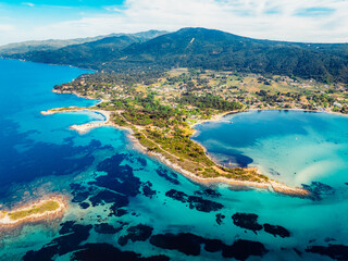 Seacoast with shades of turquoise water with beaches and blue lagoons in Karidi in Sithonia Peninsula, Vourvourou bay, Halkidiki, North Greece