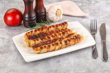 Grilled meat sausages wrapped bacon