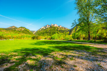 Peak Tri Koruny or Trzy Korony during day with green meadow and trees in spring. Pieniny National park in Slovakia and Poland © Zedspider
