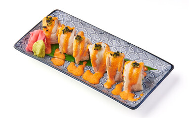 Grilled sushi rolls topped with creamy orange sauce, garnished with black tobiko, served on decorative plate with pickled ginger and wasabi for flavorful presentation