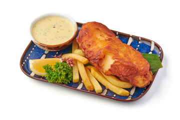Crispy golden battered fish served with thick cut fries, creamy dipping sauce, fresh parsley garnish, and lemon wedge on decorative plate, perfect for classic meal
