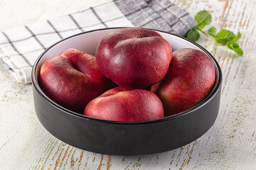 Ripe sweet juicy flat nectarines heap
