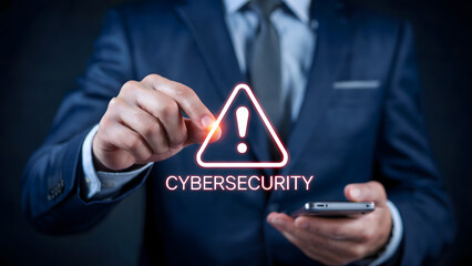 Man in suit holding phone with cybersecurity warning sign over the screen