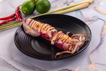 Tasty grilled wild squid with lime