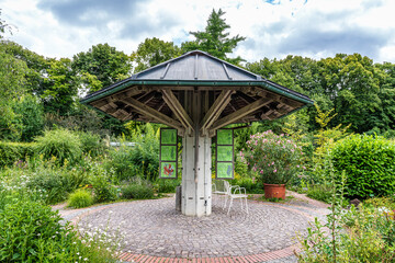 The Botanical Garden of Augsburg in Germany with garden pathes and topiary boxwood bushes on green meadows