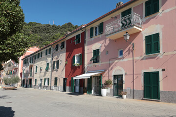 Old street in Italian countryside near sea. Traditional building. Sun day. Entrance, window to house. Nature and sky.