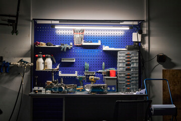 Organized tool workshop with workbench in garage for repair