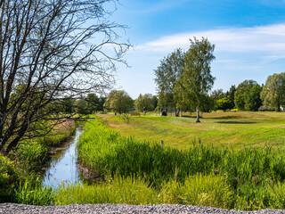 Serene Landscape with Stream and Greenery