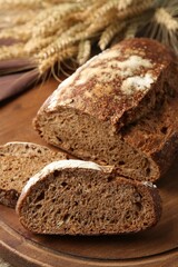 Pieces of fresh rye bread on wooden table, closeup