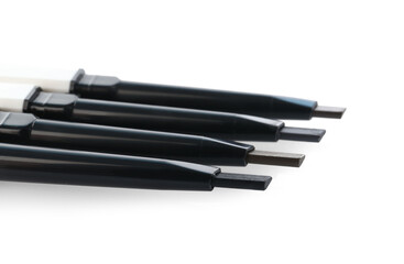Many twist up eyebrow pencils isolated on white