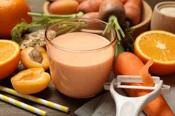 Superfood. Tasty smoothie in glass and ingredients on wooden table, closeup