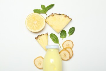 Superfood. Tasty smoothie in glass bottle and ingredients on white background, top view