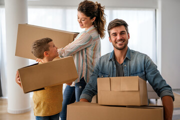 New home. Parents with child moving in new house, property mortgage and real estate investment.