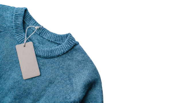 Close-up of a light teal-blue knitted sweater with a blank price tag attached to the neckline.  The sweater's texture is visible, and the tag is a simple rectangle of light beige