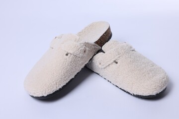 Pair of stylish slippers on white background, closeup