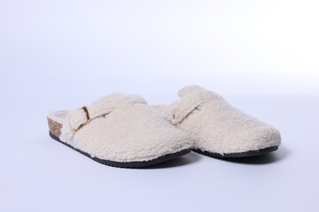 Pair of stylish slippers on white background, closeup