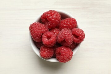 Tasty fresh ripe raspberries on white wooden table, top view