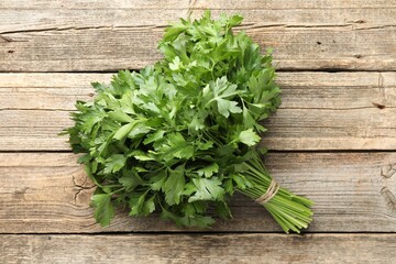 Bunch of fresh parsley on wooden table, top view