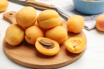 Fresh ripe apricots on white marble table, closeup