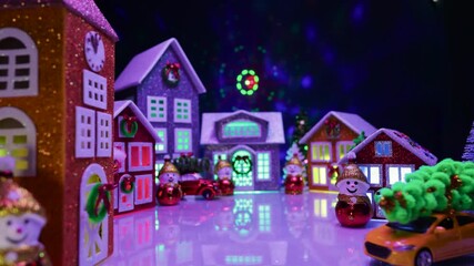Against the backdrop of laser animation, a beautiful unusual village with multi-colored lighting and multi-colored houses