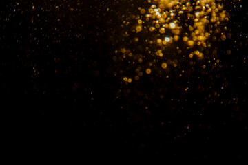 Blurred photo with golden dots visible glittering, shining brightly look and feel luxurious Suitable for use as a wallpaper