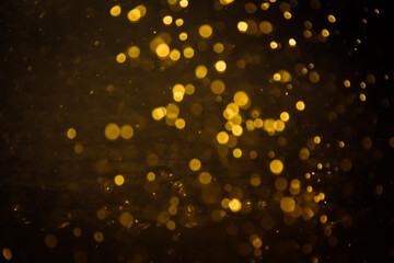 Blurred photo with golden dots visible glittering, shining brightly look and feel luxurious Suitable for use as a wallpaper