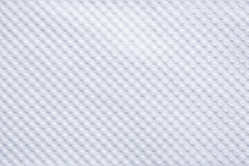  close-up of a white woven fabric, showcasing its delicate, uniform texture and subtle shadows.