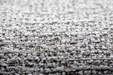 close-up shot of a tightly woven fabric with a mix of light gray and darker threads