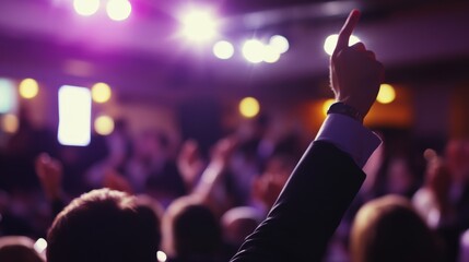 An auctioneer conducts a lively auction, with bidders enthusiastically raising their hands under bright lights