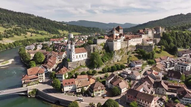 Stunning drone view of Aarburg castle above Aare river in Canton Aargau, includes Gothic church, old town, flowing water and rustic Swiss countryside.