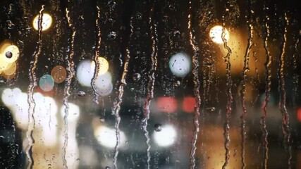 Winter raindrops on a windowpane reflecting the warm, colorful glow of a festive Christmas light decoration - Powered by Adobe