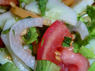 Fresh vegetable salad with tomatoes, cucumbers, and onions