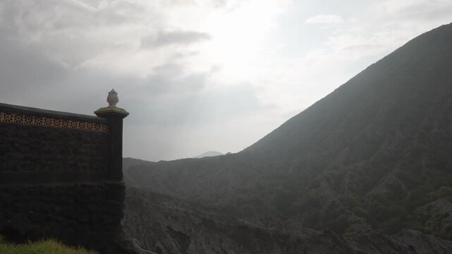 Pura luhur poten hindu temple beside the misty volcanic terrain of Mount Batok, East Java, Indonesia.
