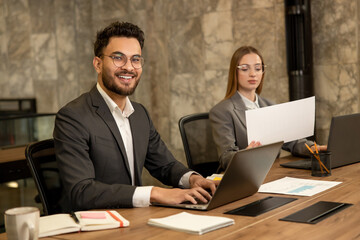 Colleagues working in the office and looking busy and involved