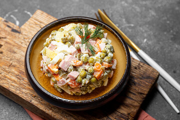  Traditional Russian salad Olivier for the New Year's table on grey background